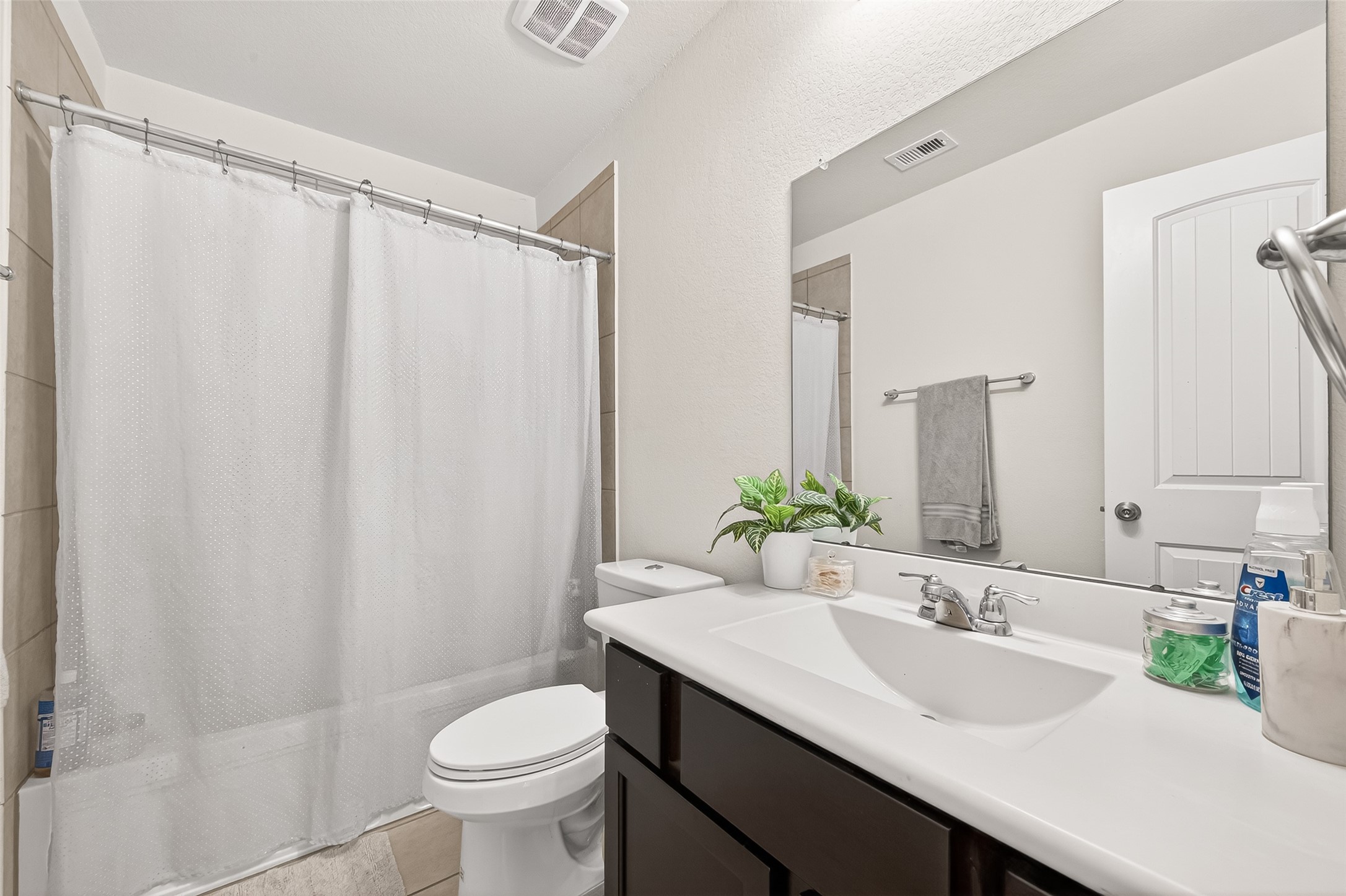 8 Landscape Court Conroe, TX 77301 - Photo 39 of 43 a bathroom with a sink a toilet a mirror and shower curtain