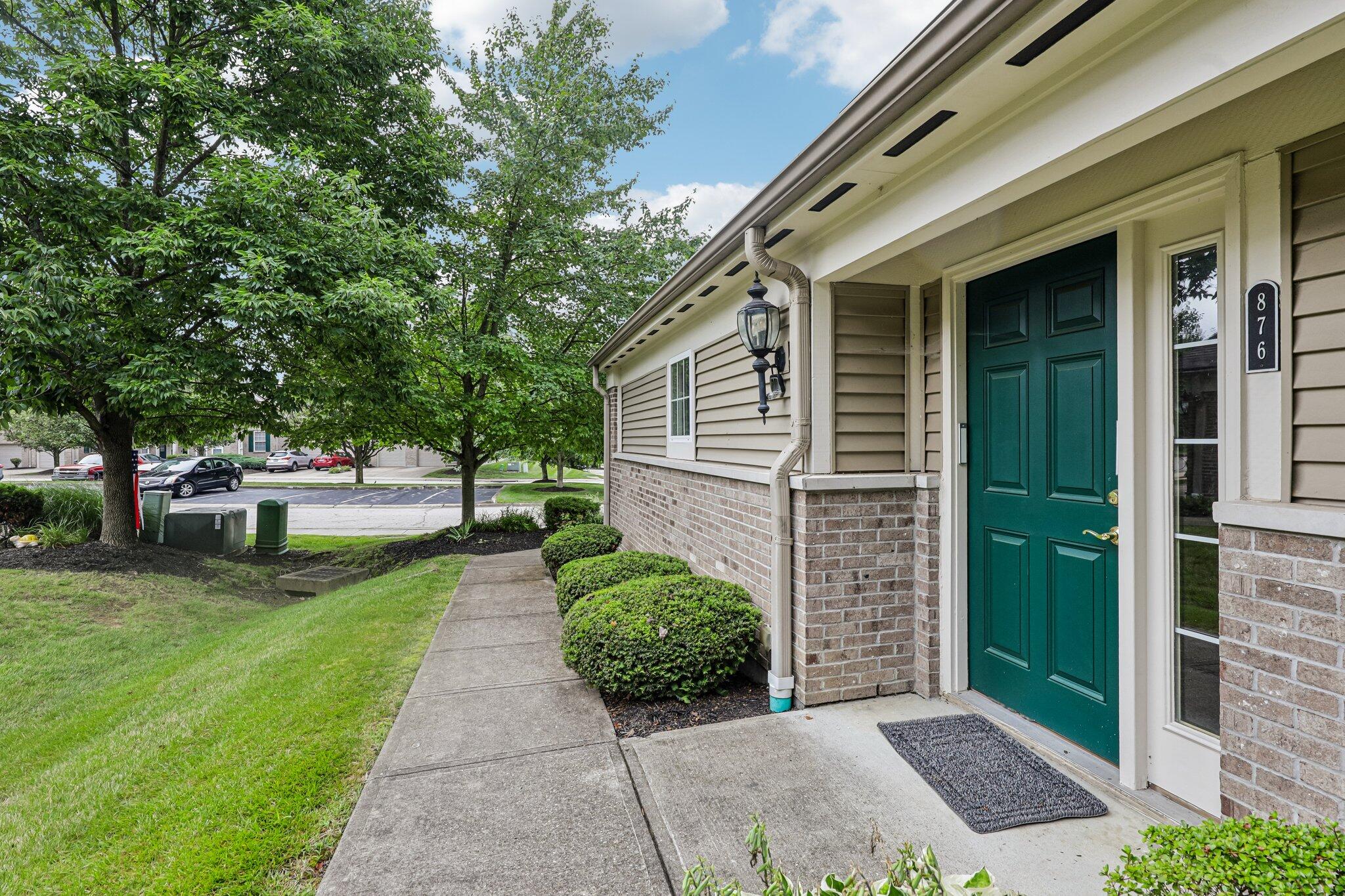 876 Flint Ridge Newport, KY 41076 - Photo 10 of 43 Front entrance featuring a paneled teal door, brick and siding exterior, and a built-in exterior light fixture