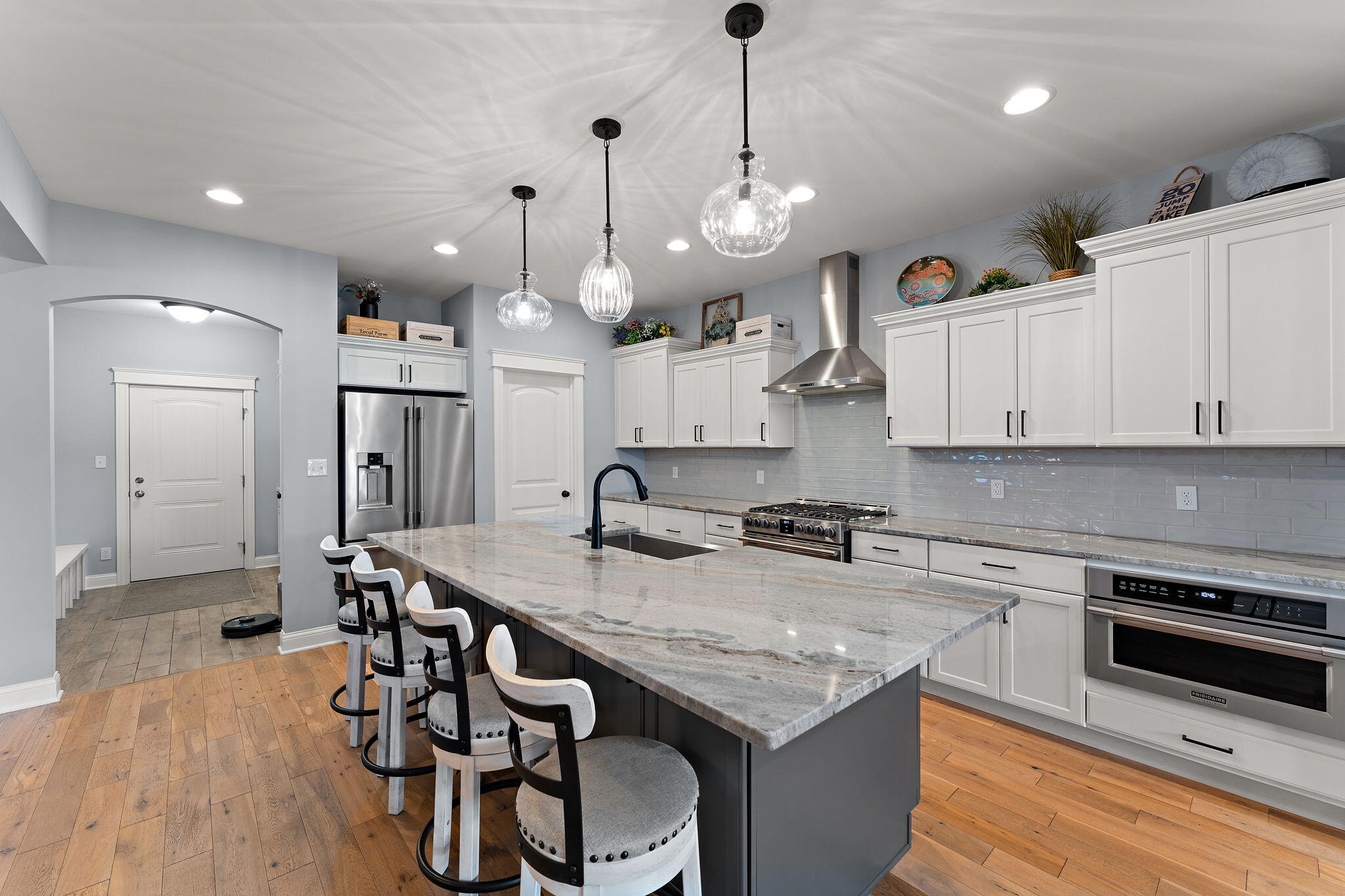 5956 Beacon Lane Portage, IN 46368 - Photo 11 of 57 a kitchen with granite countertop kitchen island stainless steel appliances a stove sink and refrigerator