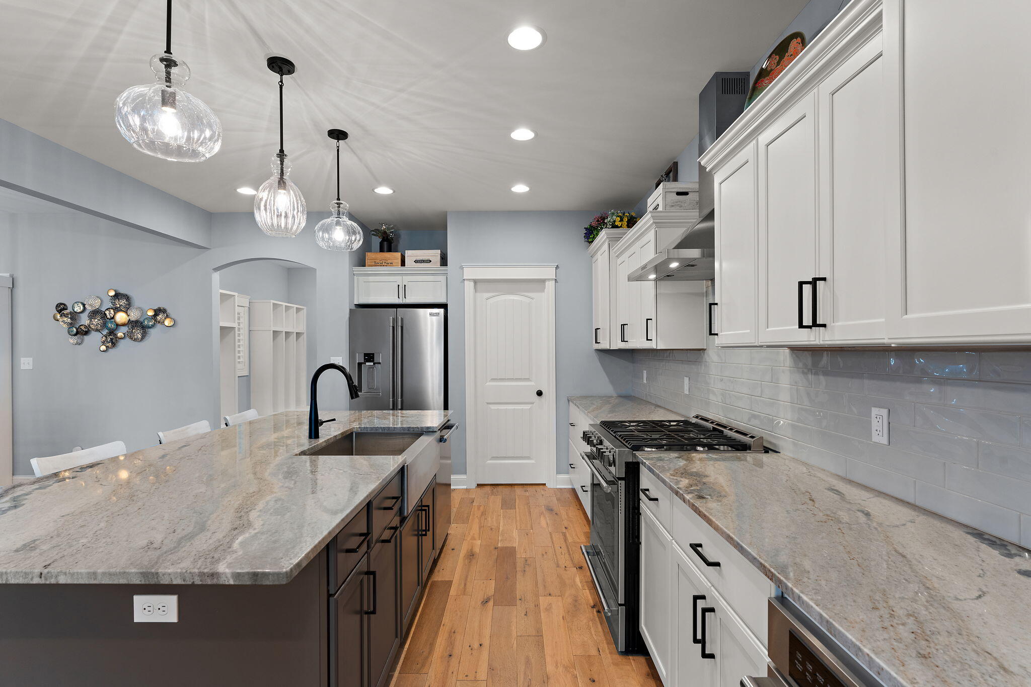 5956 Beacon Lane Portage, IN 46368 - Photo 12 of 57 a kitchen with kitchen island granite countertop a sink stainless steel appliances and cabinets