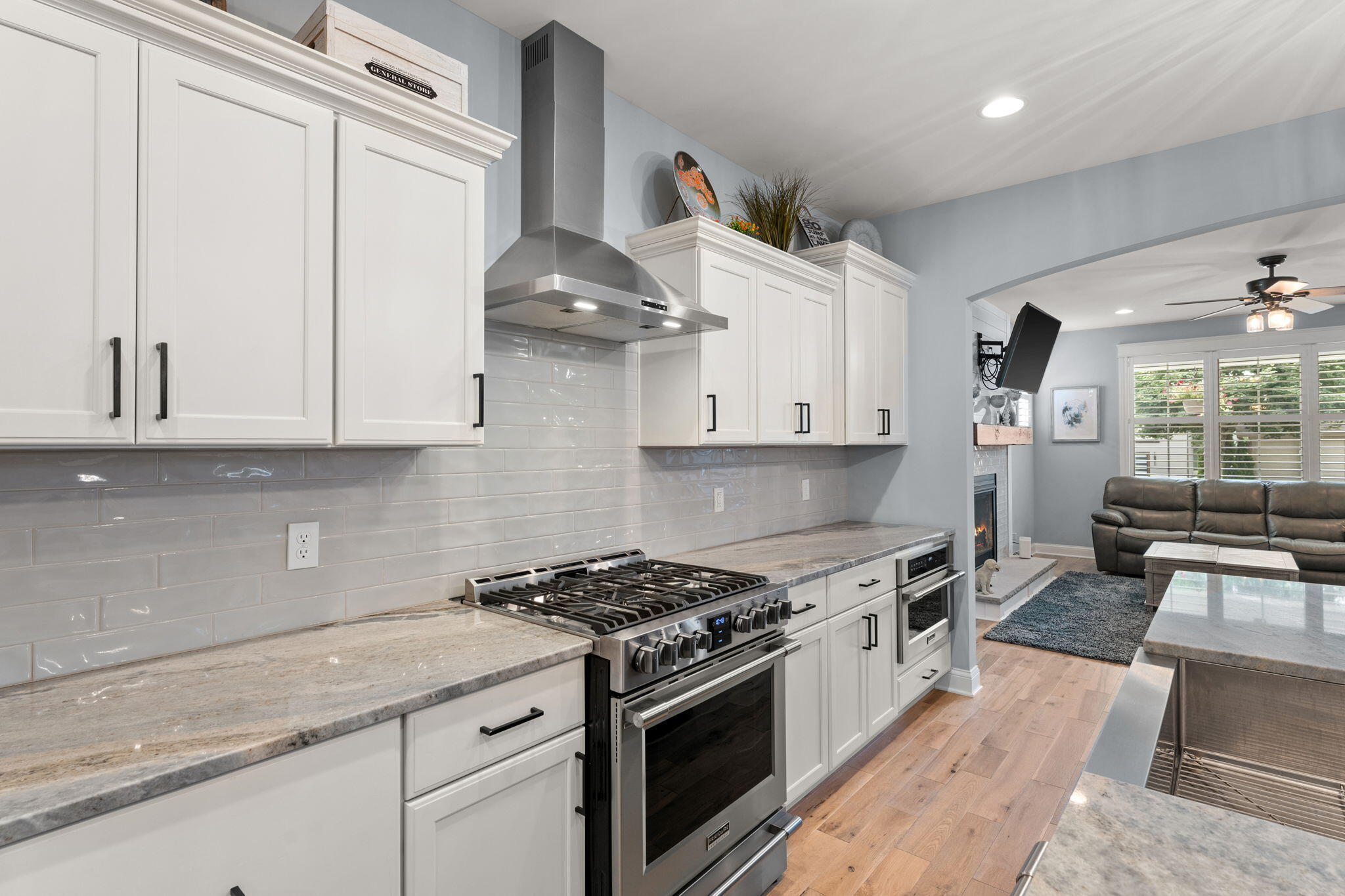 5956 Beacon Lane Portage, IN 46368 - Photo 14 of 57 a kitchen with stainless steel appliances granite countertop a stove a sink and white cabinets