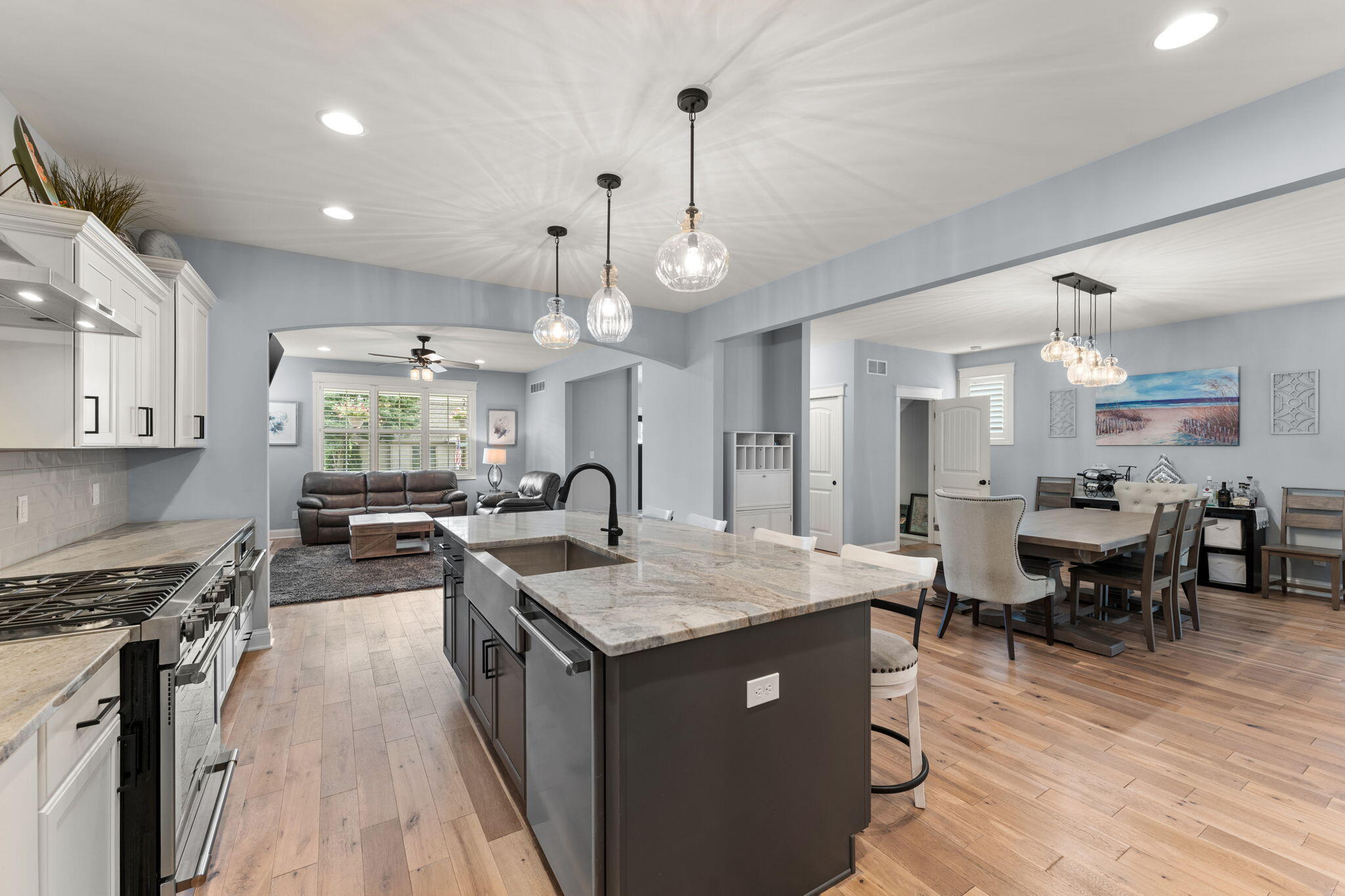 5956 Beacon Lane Portage, IN 46368 - Photo 15 of 57 a kitchen with stainless steel appliances granite countertop a sink stove and wooden floor