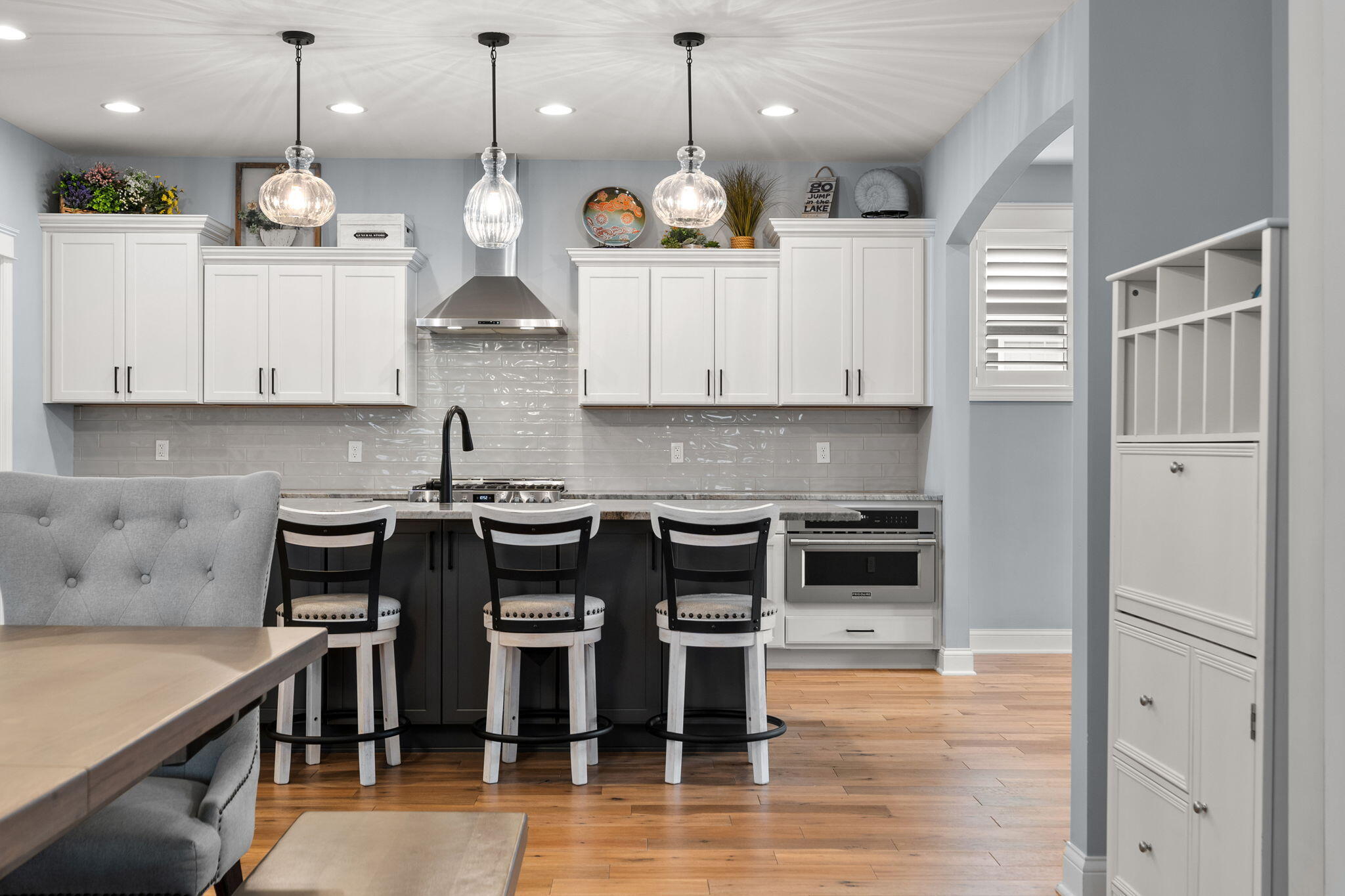 5956 Beacon Lane Portage, IN 46368 - Photo 16 of 57 a kitchen with kitchen island granite countertop a stove a sink a center island and a wooden floor