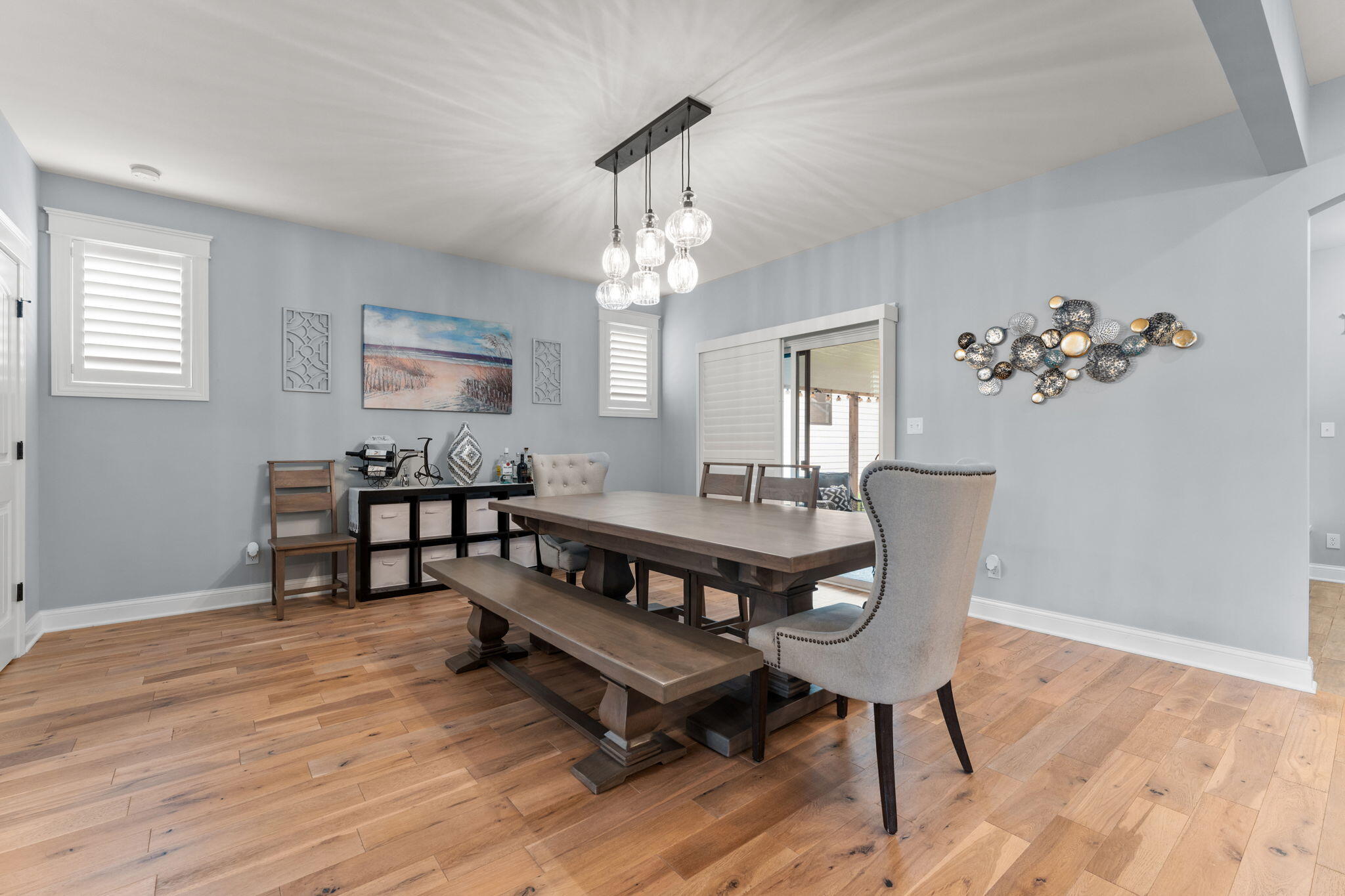 5956 Beacon Lane Portage, IN 46368 - Photo 17 of 57 a dining room with furniture a chandelier and wooden floor