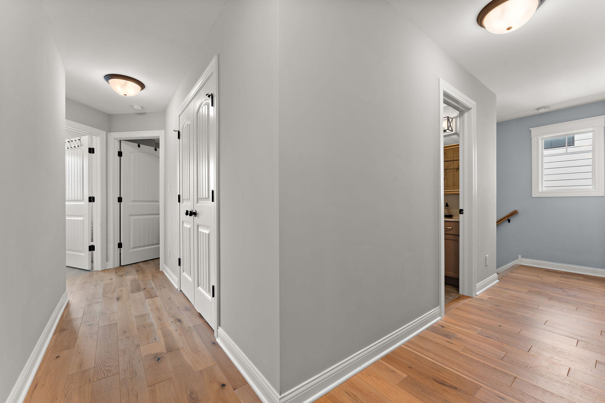 5956 Beacon Lane Portage, IN 46368 - Photo 25 of 57 a view of a hallway with wooden floor and a bathroom