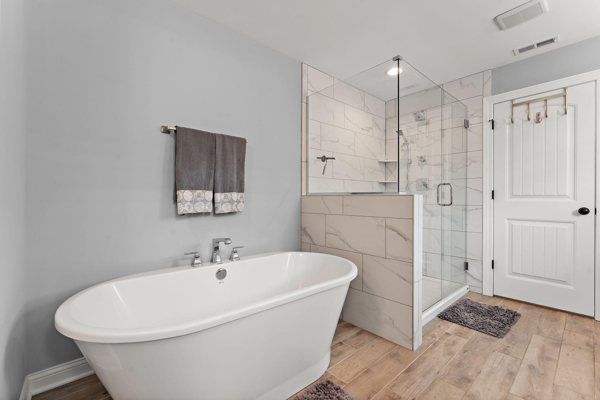 5956 Beacon Lane Portage, IN 46368 - Photo 35 of 57 a white bath tub sitting in a bathroom and shower