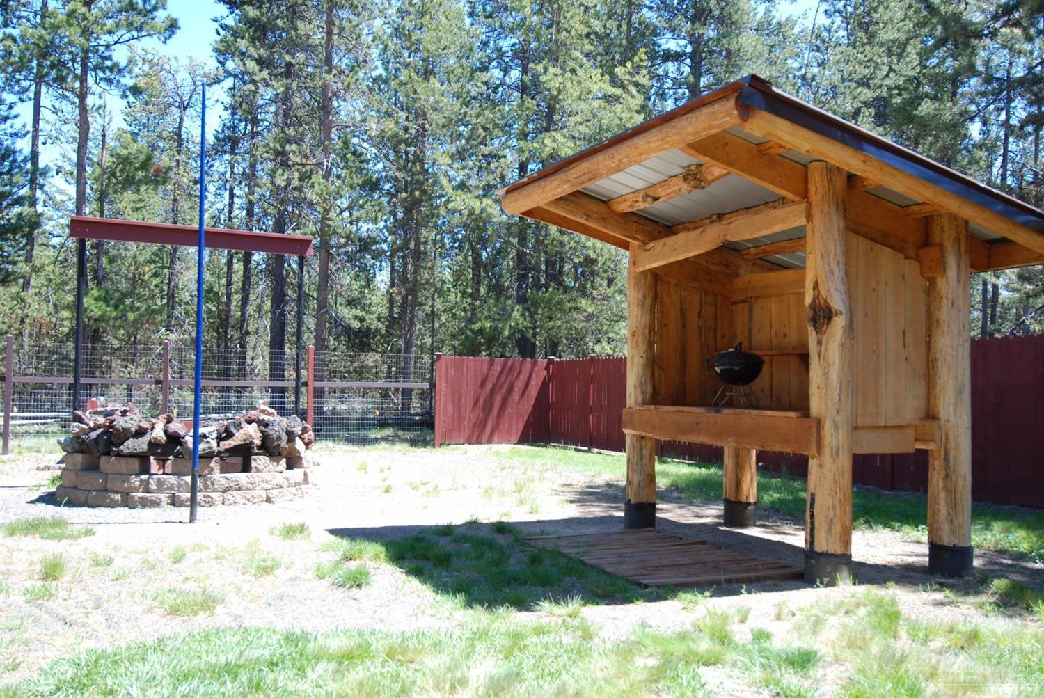 55726 Snow Goose Road Bend, OR 97707 - Photo 23 of 25 a view of house with yard outdoor seating and plants