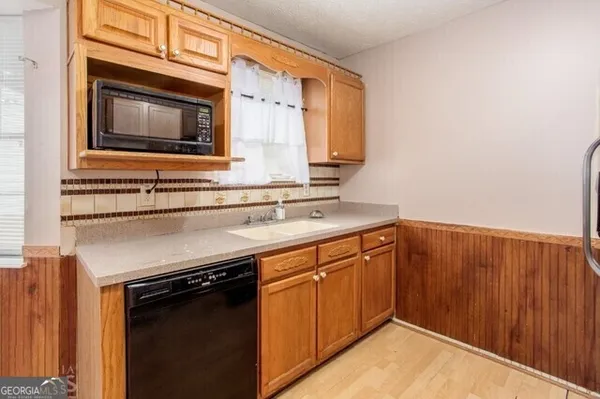 a kitchen with a sink stove and microwave