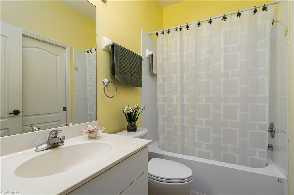 1927 Morning Sun Lane, Unit F27 Naples, FL 34119 - Photo 15 of 17 a bathroom with a sink a toilet and shower