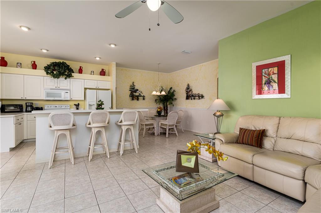 1927 Morning Sun Lane, Unit F27 Naples, FL 34119 - Photo 7 of 17 a living room with furniture and a kitchen view