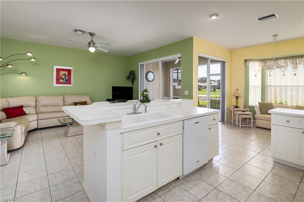 1927 Morning Sun Lane, Unit F27 Naples, FL 34119 - Photo 9 of 17 a bathroom with a double vanity sink mirror and toilet