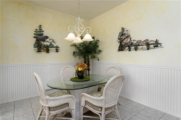 a dining room with furniture and chandelier