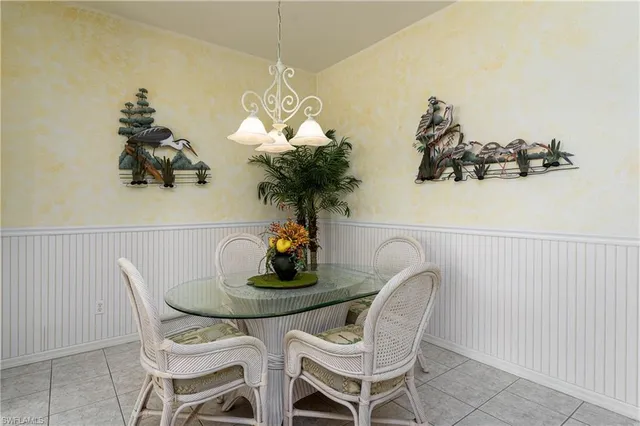 a dining room with furniture and chandelier