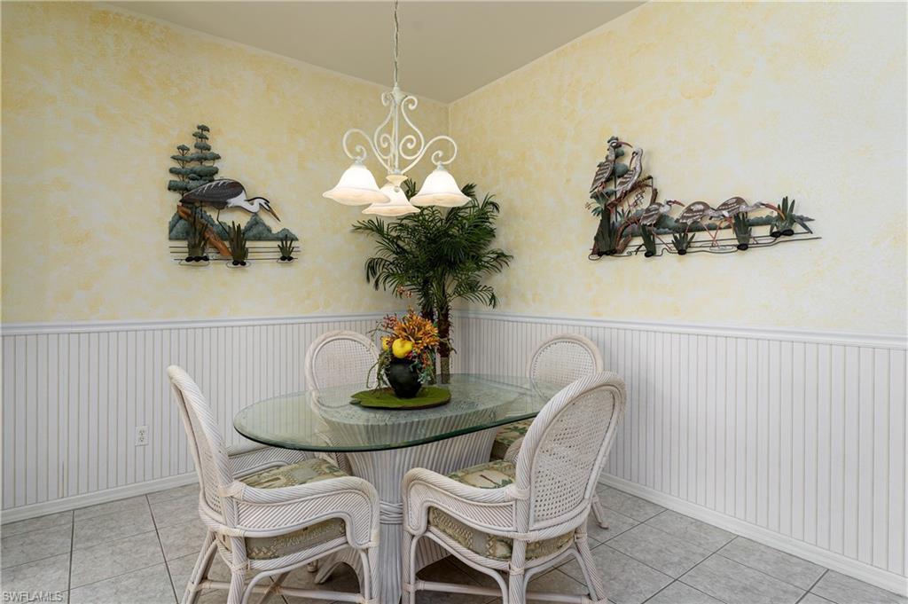 1927 Morning Sun Lane, Unit F27 Naples, FL 34119 - Photo 10 of 17 a dining room with furniture and chandelier