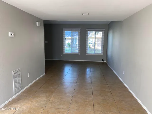 a view of a livingroom with wooden floor and a window