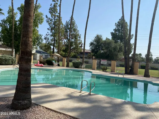 a view of a park with plants and a fountain