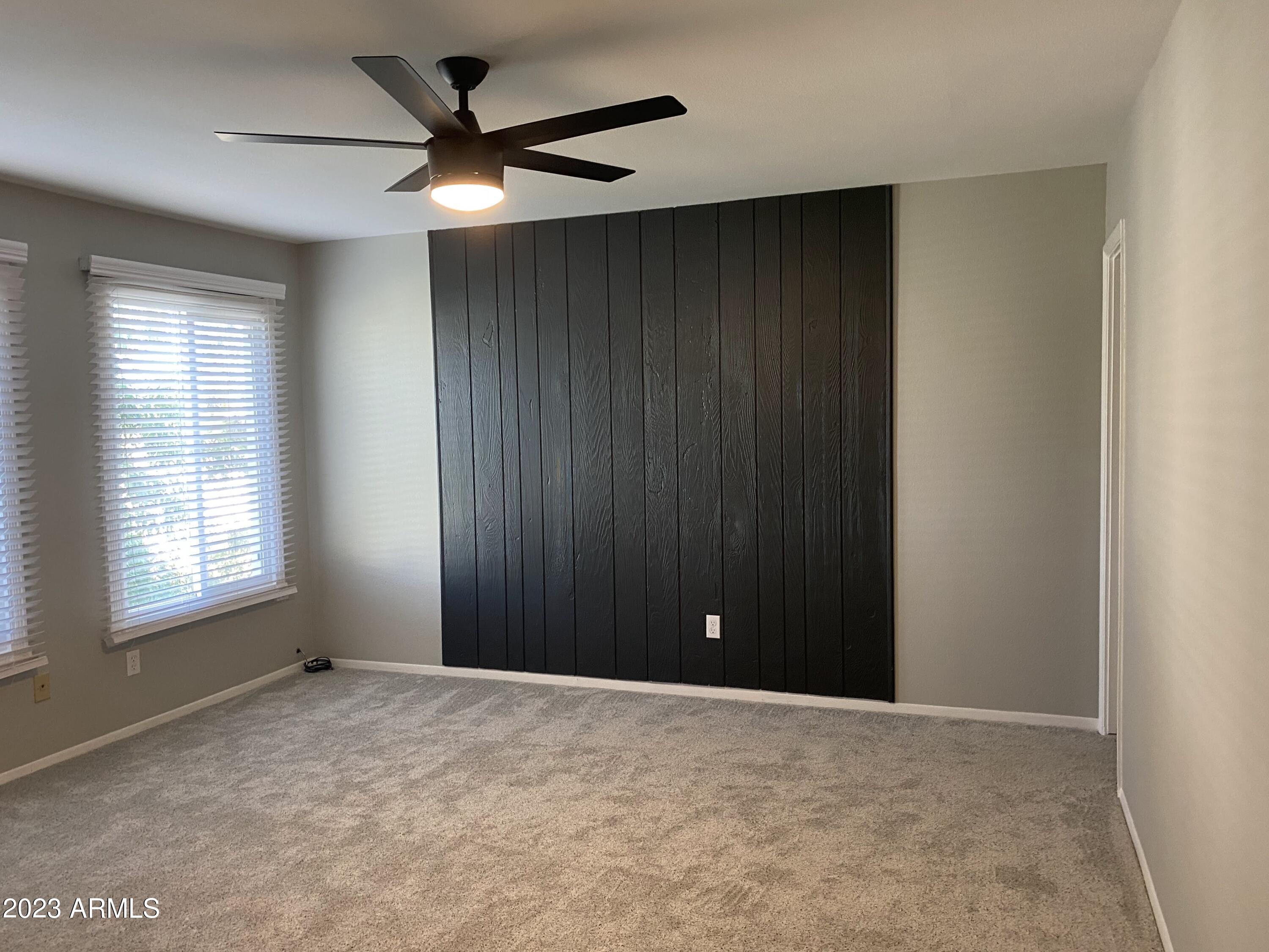 6617 South Granada Drive Tempe, AZ 85283 - Photo 5 of 20 a view of an empty room with a ceiling fan and window