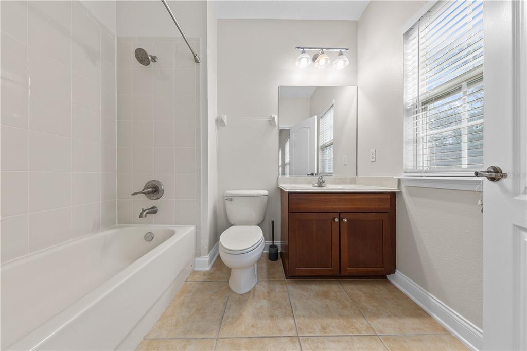7224 Halton Court Windermere, FL 34786 - Photo 28 of 50 a bathroom with a bathtub a sink a toilet and a mirror