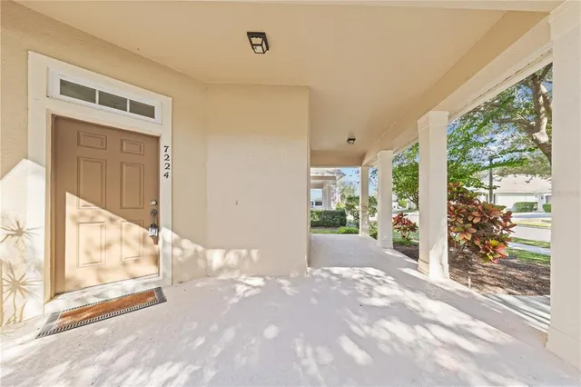 a view of an empty room with wooden floor and stairs