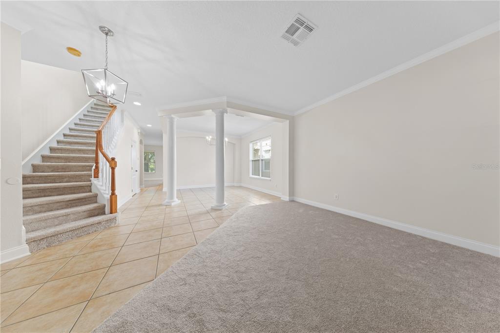7224 Halton Court Windermere, FL 34786 - Photo 6 of 50 a view of an empty room with wooden floor and stairs