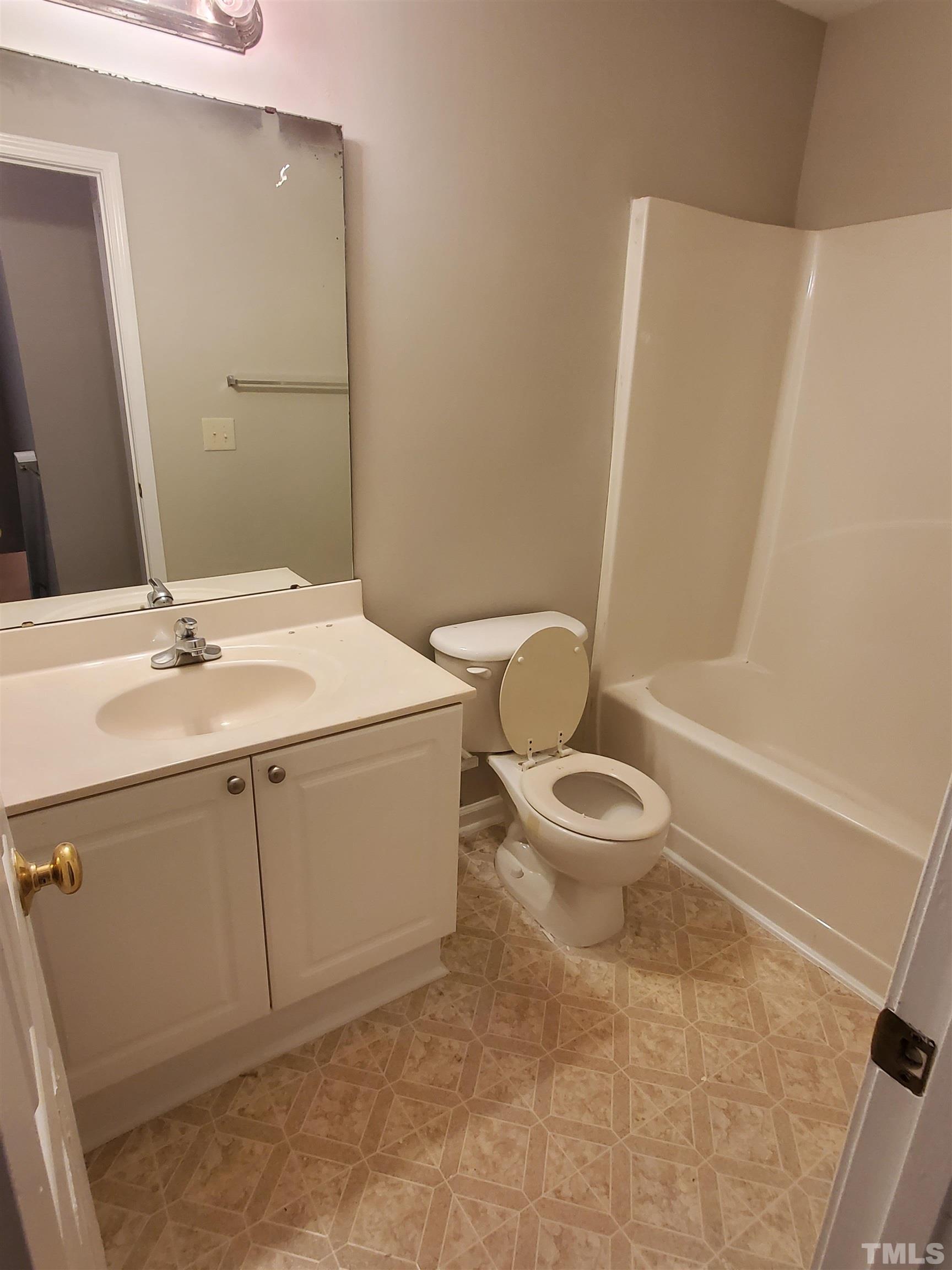 4216 Beacon Crest Way Raleigh, NC 27604 - Photo 13 of 22 a bathroom with a sink a toilet and a mirror