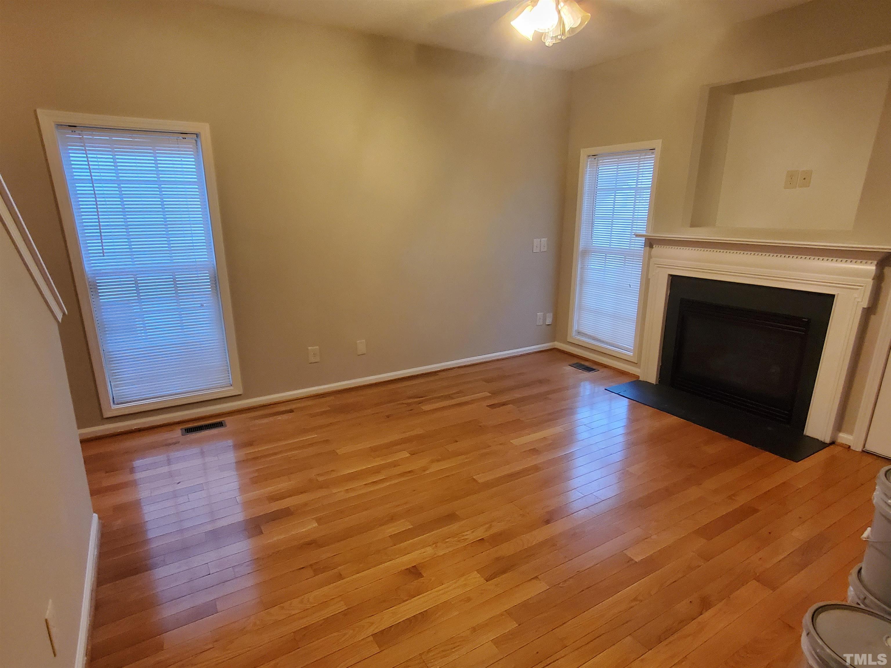 4216 Beacon Crest Way Raleigh, NC 27604 - Photo 7 of 22 a view of an empty room with wooden floor and a window