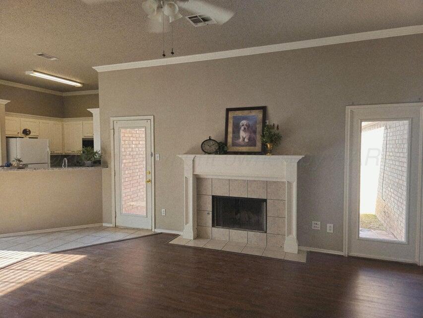 1918 75th Street Lubbock, TX 79423 - Photo 2 of 14 a view of a livingroom with wooden floor and a fireplace