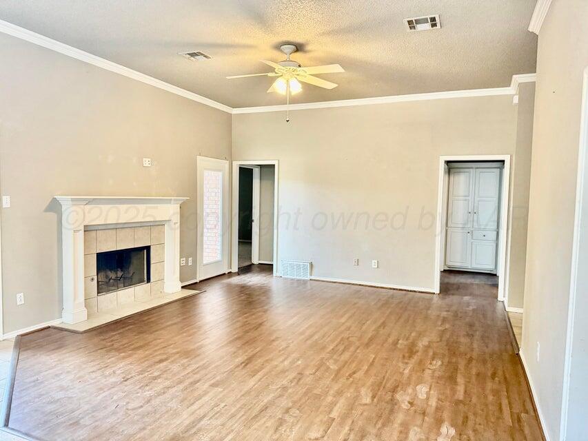1918 75th Street Lubbock, TX 79423 - Photo 5 of 14 a view of a livingroom with a fireplace and a ceiling fan