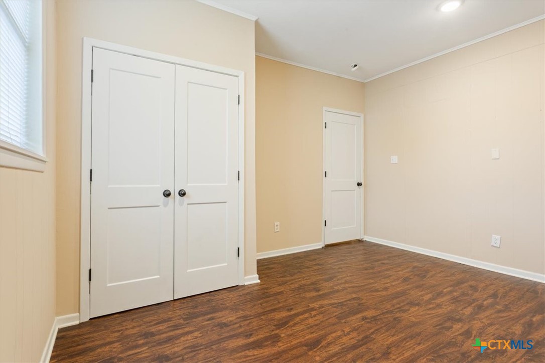 1219 South 17th Street Temple, TX 76504 - Photo 15 of 24 a view of an empty room with wooden floor