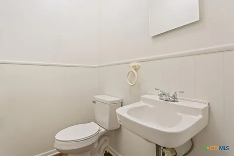 a white toilet sitting next to a bathroom sink
