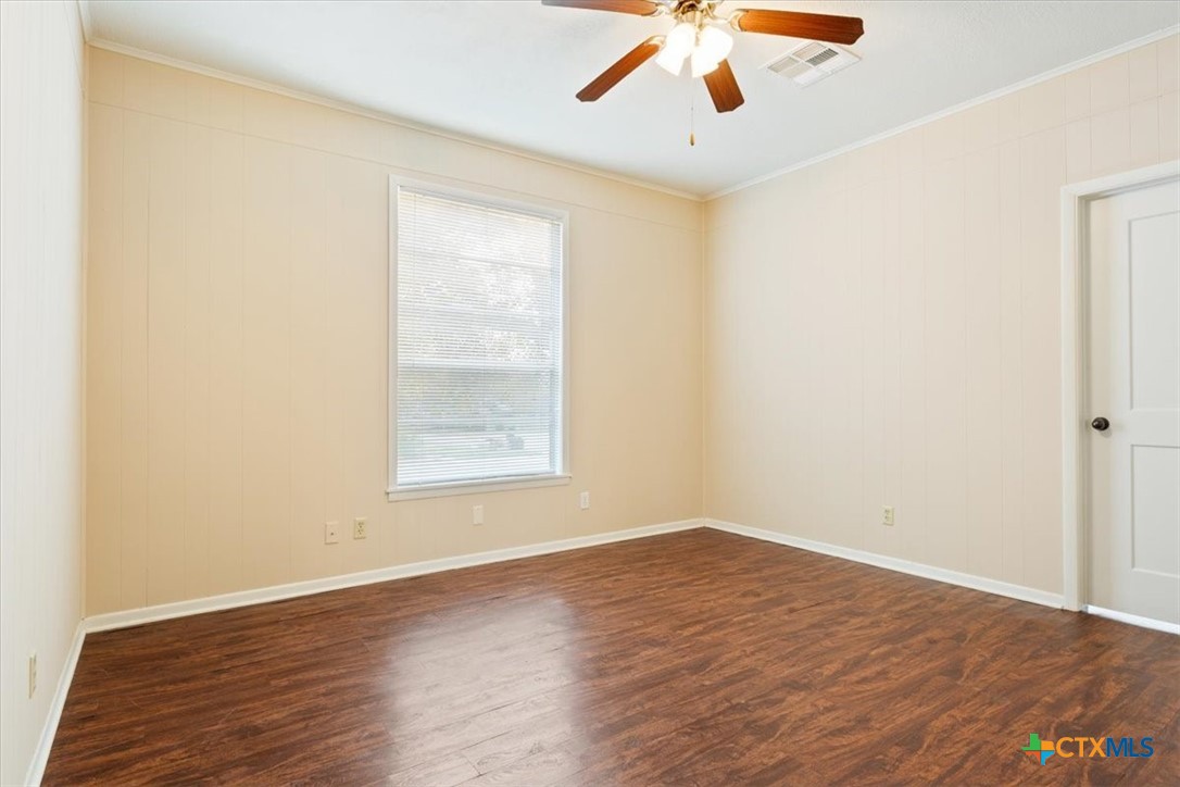 1219 South 17th Street Temple, TX 76504 - Photo 17 of 24 an empty room with wooden floor and windows
