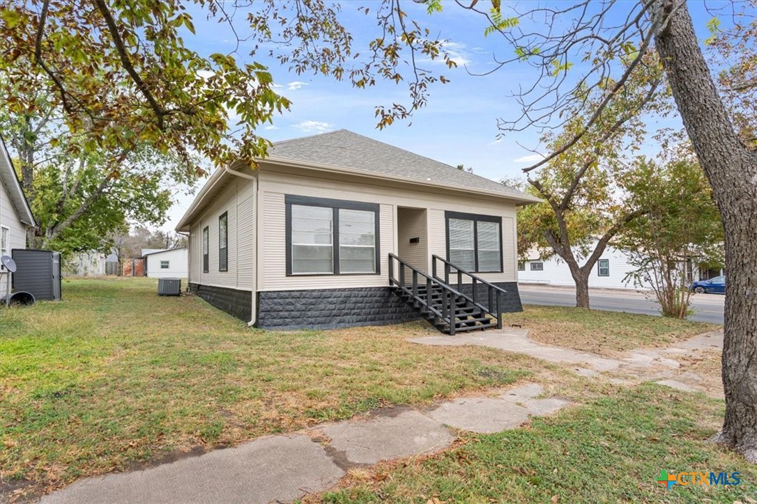 1219 South 17th Street Temple, TX 76504 - Photo 2 of 24 a view of a house with a yard covered in snow