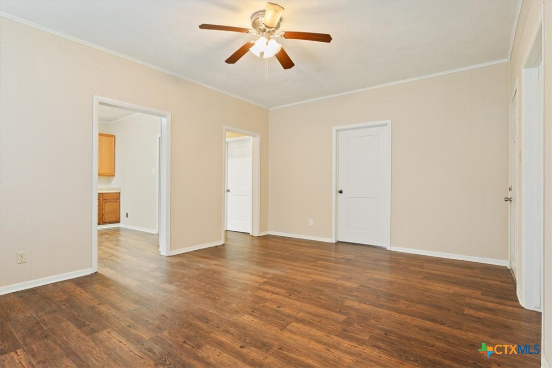 1219 South 17th Street Temple, TX 76504 - Photo 6 of 24 an empty room with wooden floor and ceiling fan
