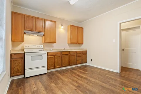 a kitchen with stainless steel appliances granite countertop a stove and a refrigerator