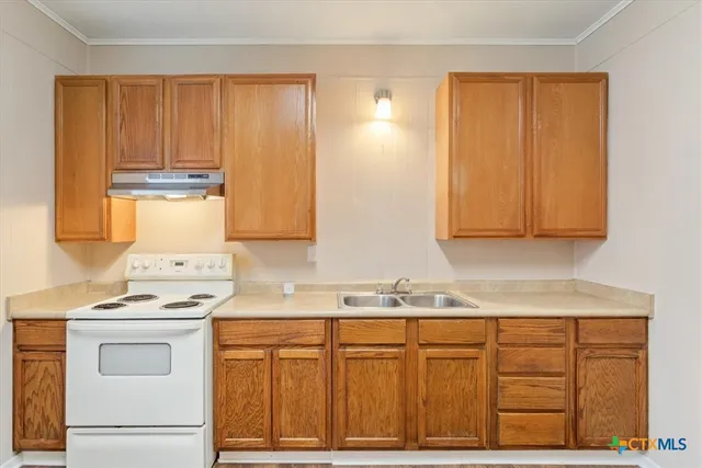 a kitchen with granite countertop cabinets stainless steel appliances and sink