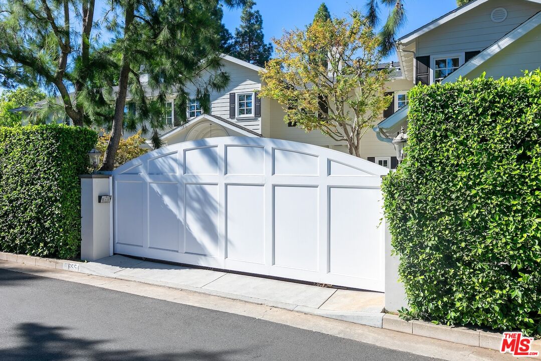 655 North Faring Road Los Angeles, CA 90077 - Photo 2 of 23 a white house that has tree in front of it