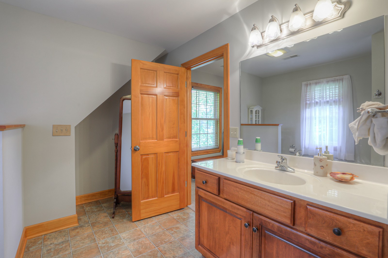 1421 Pea Ridge Road Manchester, TN 37355 - Photo 27 of 62 a bathroom with a double vanity sink a mirror and a shower