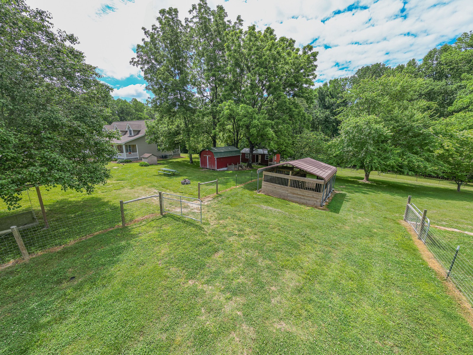 1421 Pea Ridge Road Manchester, TN 37355 - Photo 61 of 62 a backyard of a house with table and chairs