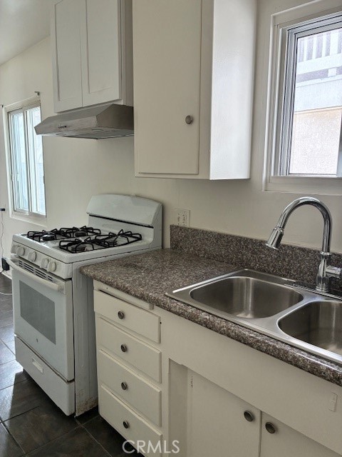 640 West Imperial Avenue, Unit 3 El Segundo, CA 90245 - Photo 6 of 9 a kitchen with granite countertop white cabinets sink and appliances