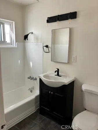 a bathroom with a sink toilet and bathtub