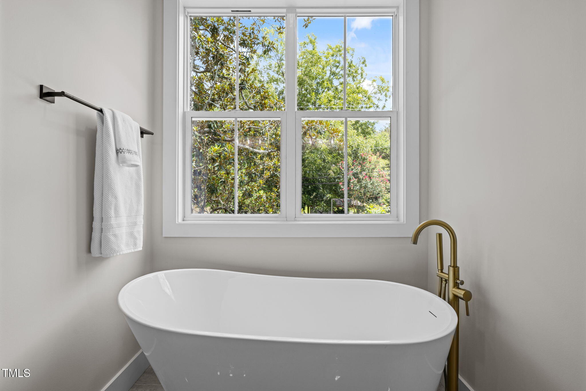 121 West Braxton Foushee Street Carrboro, NC 27510 - Photo 22 of 50 a white bath tub sitting in a bathroom next to a window