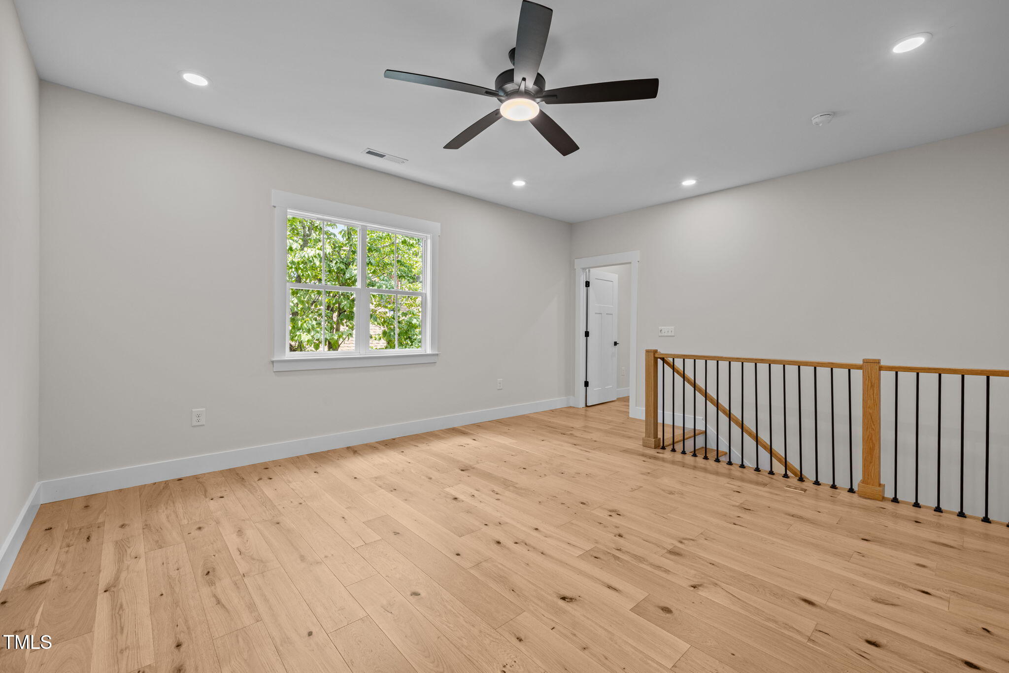 121 West Braxton Foushee Street Carrboro, NC 27510 - Photo 26 of 50 an empty room with wooden floor chandelier fan and windows