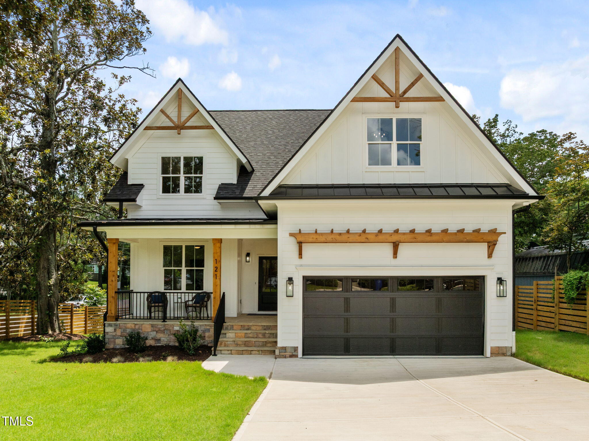 121 West Braxton Foushee Street Carrboro, NC 27510 - Photo 1 of 50 a front view of a house with a yard and garage