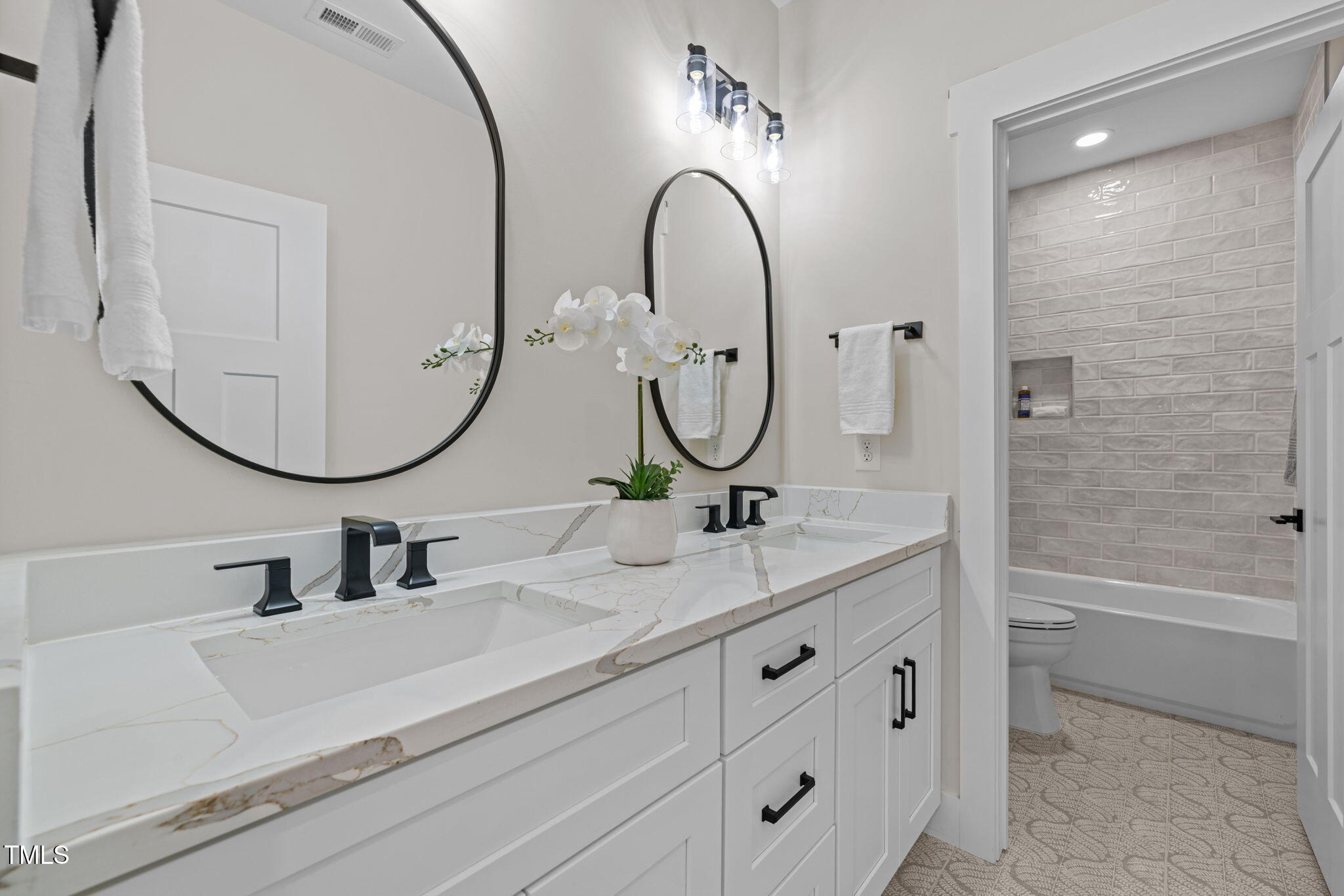 121 West Braxton Foushee Street Carrboro, NC 27510 - Photo 31 of 50 a bathroom with a double vanity sink double mirror and bathtub