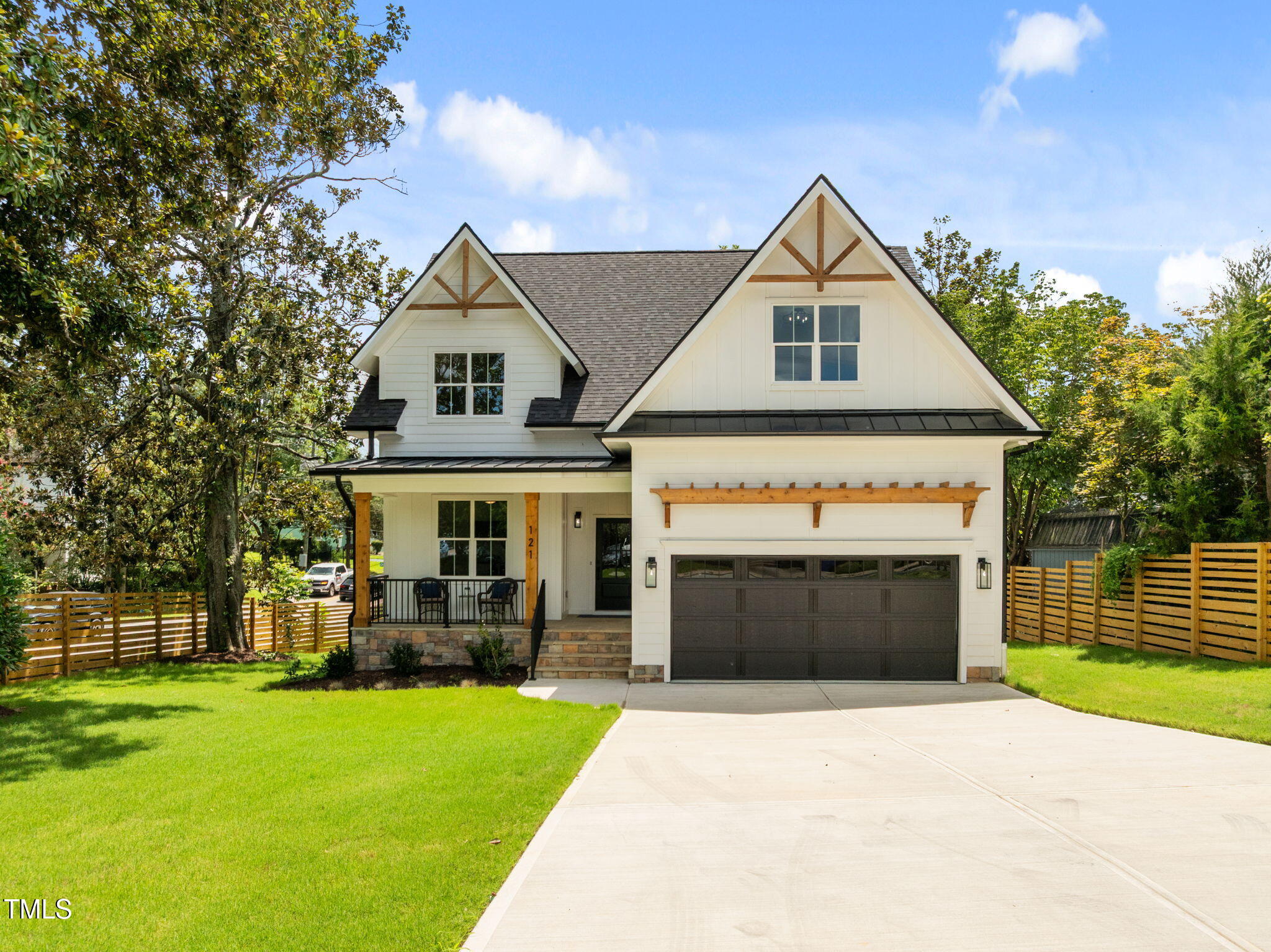 121 West Braxton Foushee Street Carrboro, NC 27510 - Photo 46 of 50 a front view of a house with a yard and garage