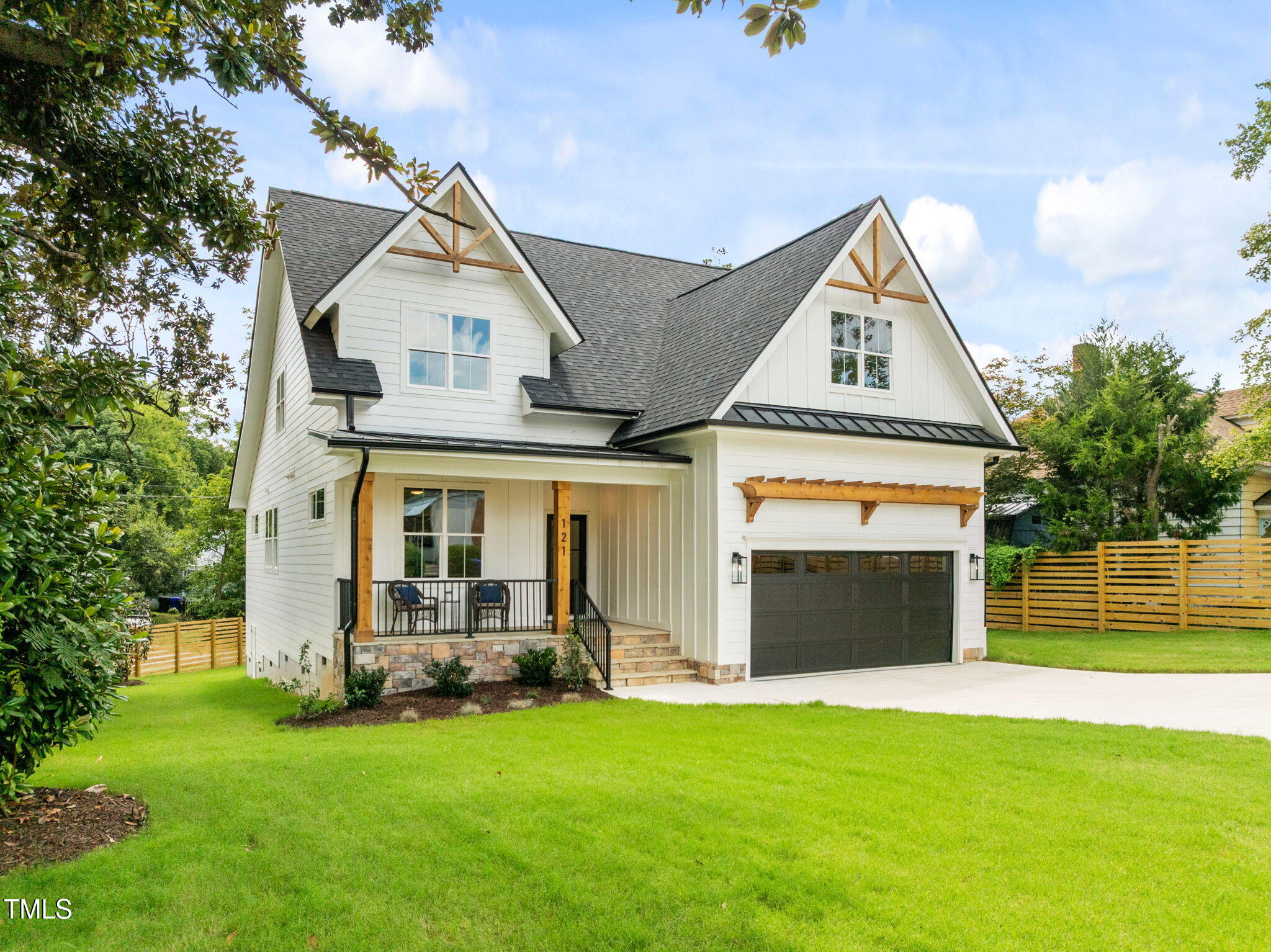 121 West Braxton Foushee Street Carrboro, NC 27510 - Photo 47 of 50 a front view of a house with a yard and garage