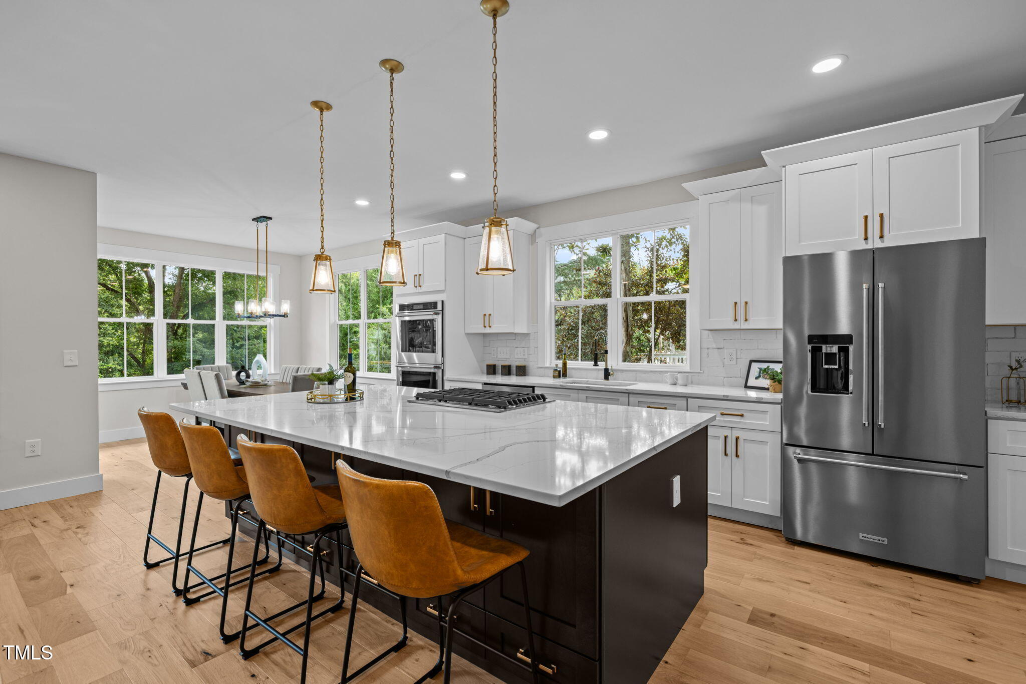 121 West Braxton Foushee Street Carrboro, NC 27510 - Photo 3 of 50 a kitchen with stainless steel appliances granite countertop a table chairs sink refrigerator and microwave
