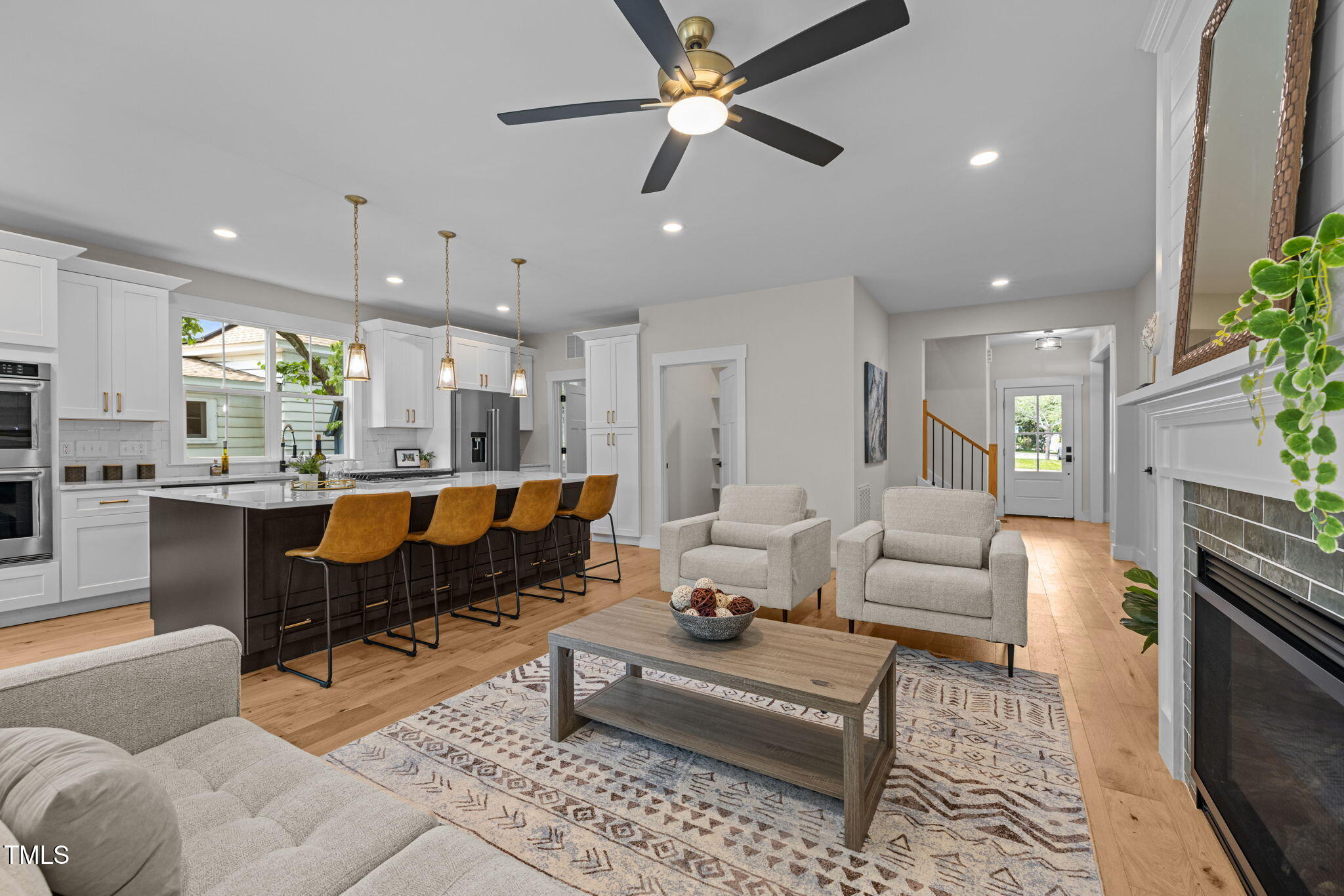 121 West Braxton Foushee Street Carrboro, NC 27510 - Photo 5 of 50 a living room with furniture kitchen view and a chandelier