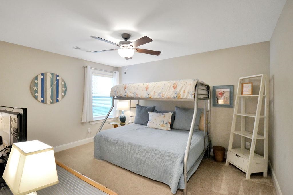 70 Trinity Cove Atoka, TN 38004 - Photo 13 of 20 a bedroom with a large bed and a chandelier