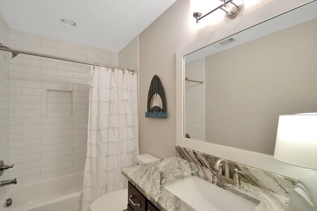 70 Trinity Cove Atoka, TN 38004 - Photo 14 of 20 a bathroom with a granite countertop sink a mirror and shower